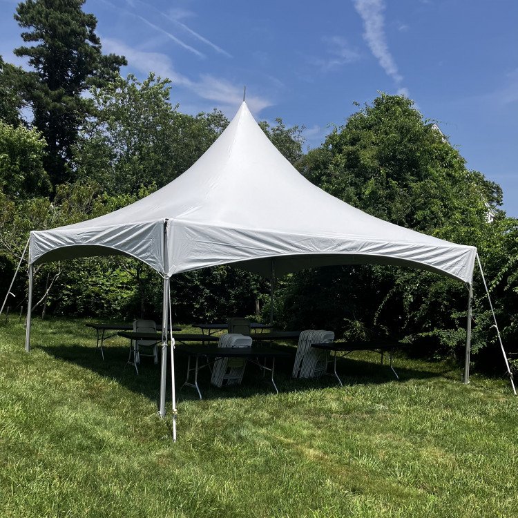 white marquee tent setup in a backyard