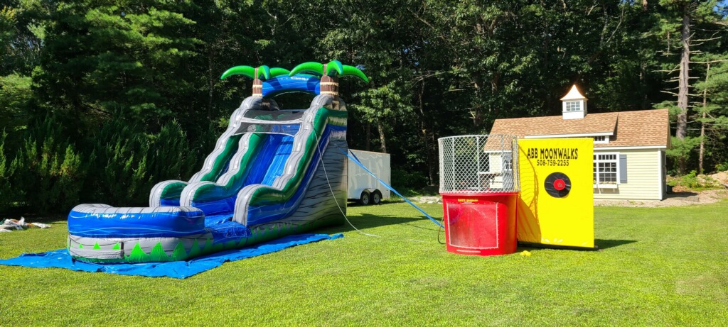 water slide and dunk tank rental setup in a plymouth, ma backyard